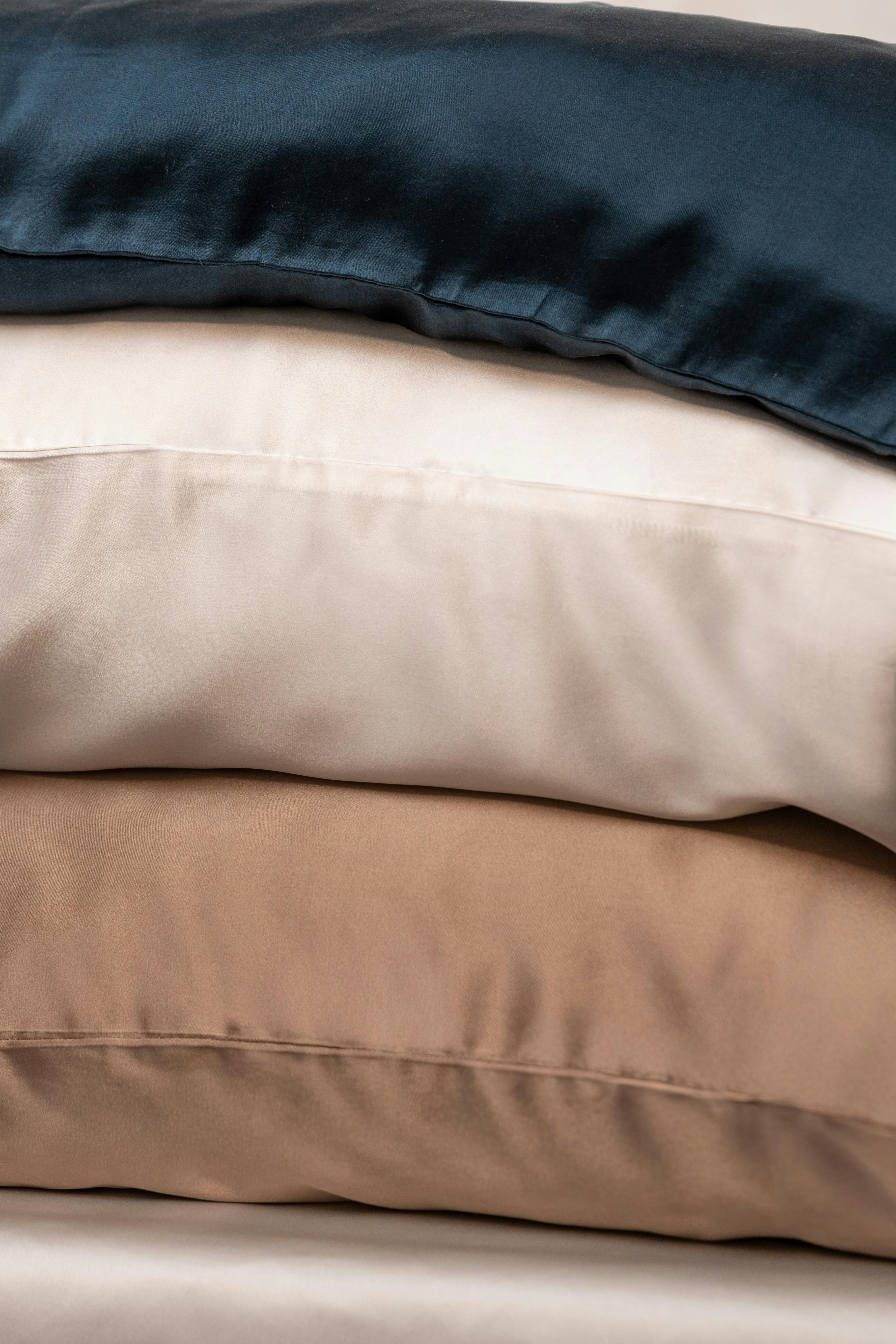 Stack of mulberry silk pillowcases in assorted colours