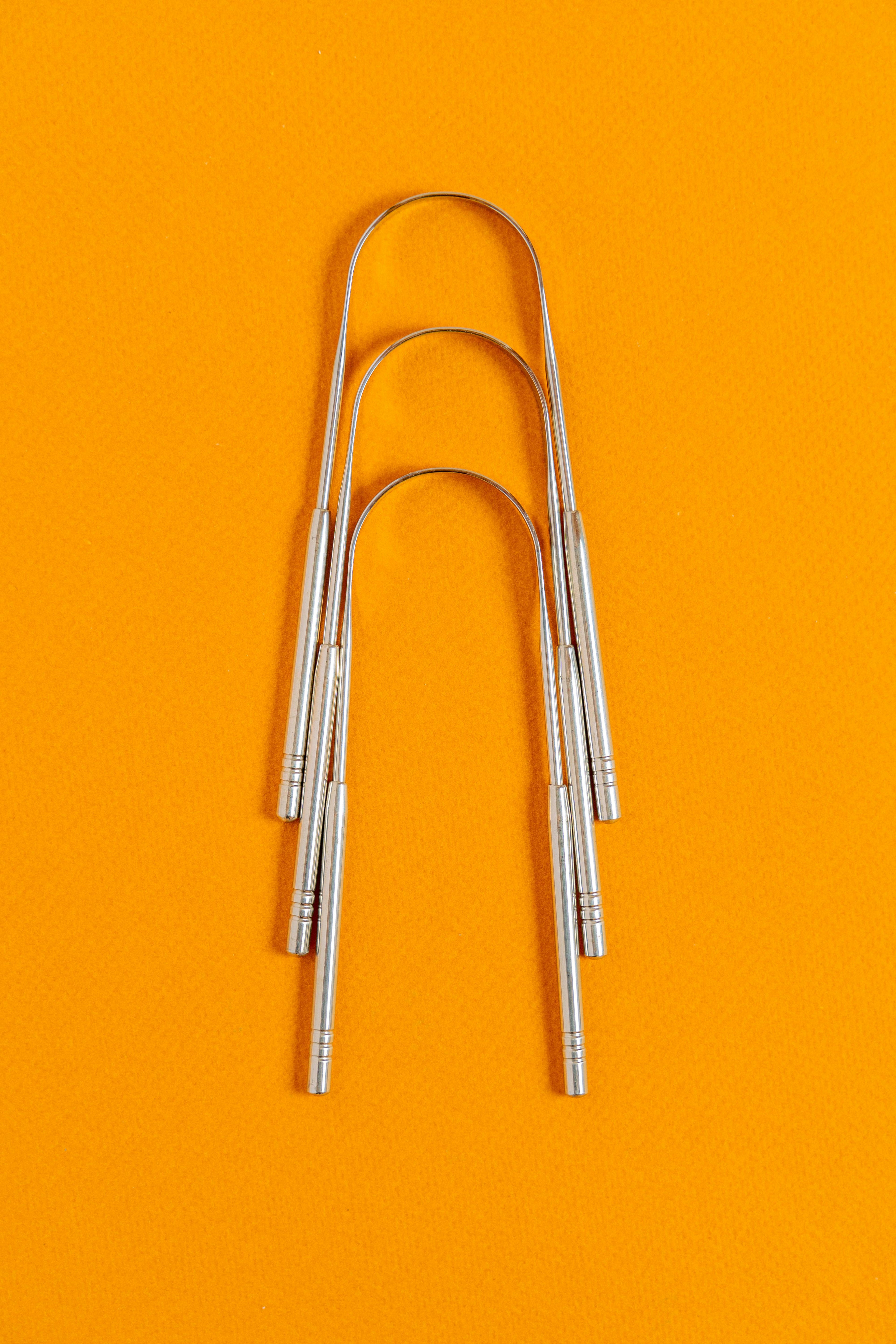 Metal tongue scrapers for natural oral care
