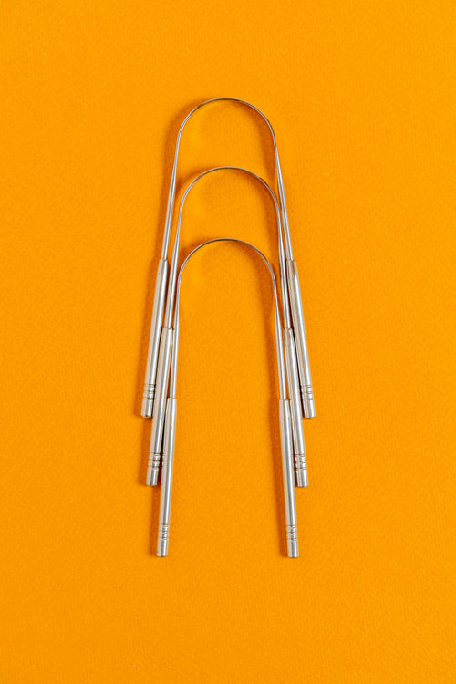 Metal tongue scrapers for natural oral care